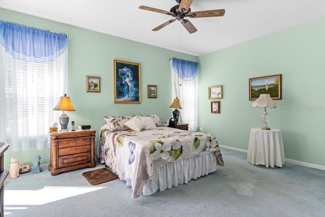 bedroom featuring ceiling fan, carpet, and multiple windows