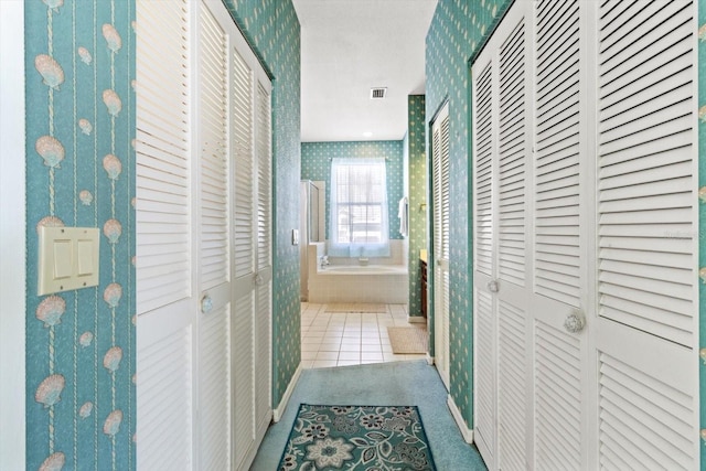 corridor featuring light tile patterned floors