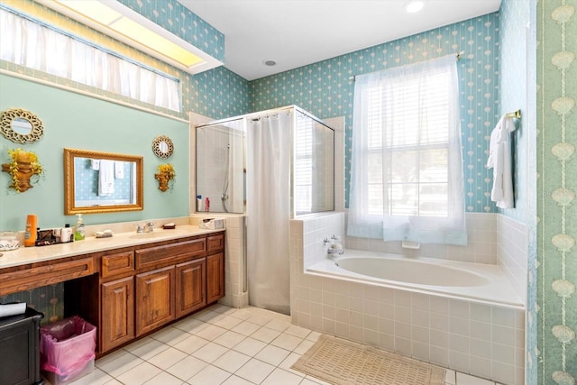 bathroom featuring shower with separate bathtub, vanity, and tile patterned flooring