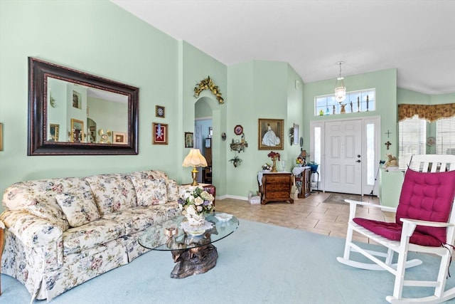 tiled living room featuring a towering ceiling