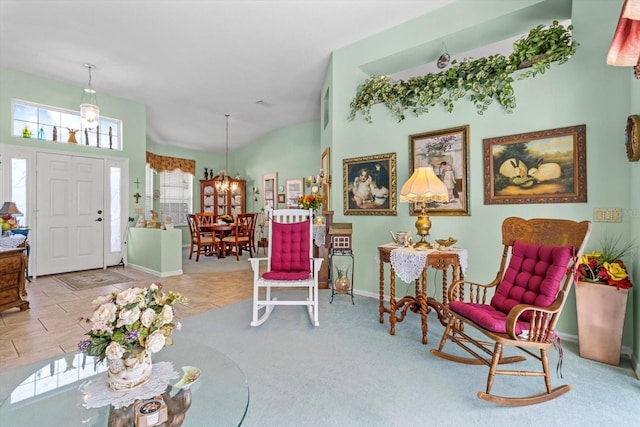 sitting room with vaulted ceiling, light tile patterned floors, and a notable chandelier