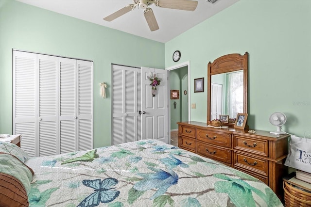 bedroom featuring ceiling fan and multiple closets