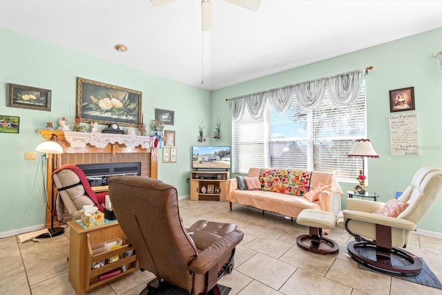 living area with ceiling fan and light tile patterned floors