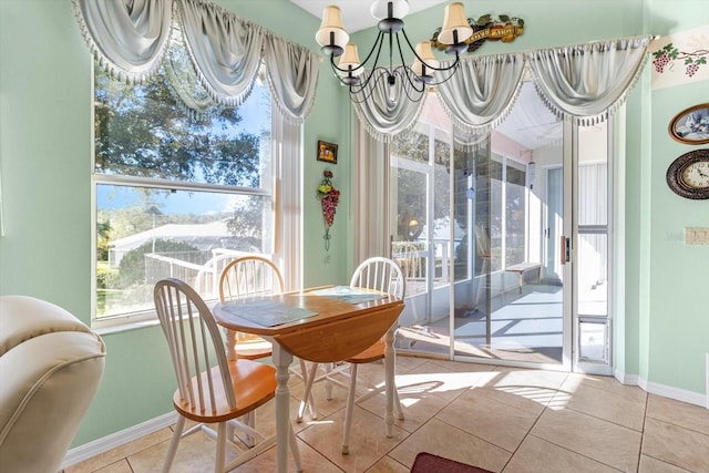 dining area featuring light tile patterned flooring and an inviting chandelier