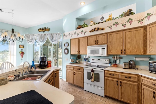 kitchen with pendant lighting, white appliances, sink, a chandelier, and light tile patterned flooring