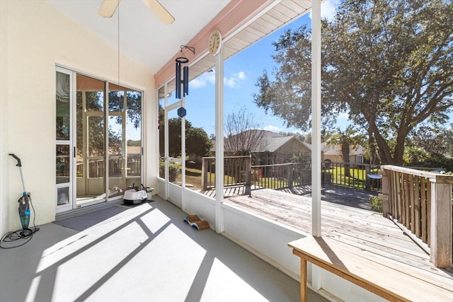 unfurnished sunroom featuring ceiling fan and vaulted ceiling