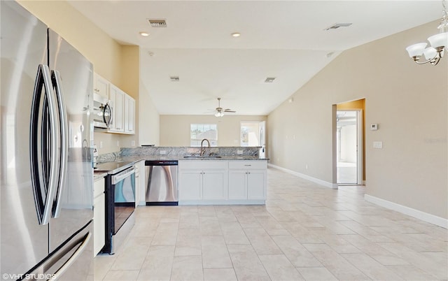 kitchen featuring lofted ceiling, white cabinets, sink, and stainless steel appliances