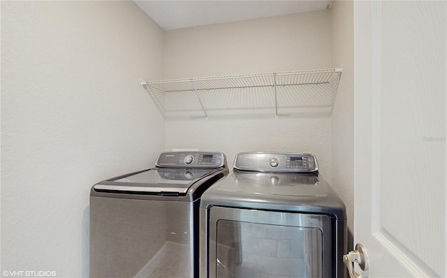 washroom featuring washer and clothes dryer