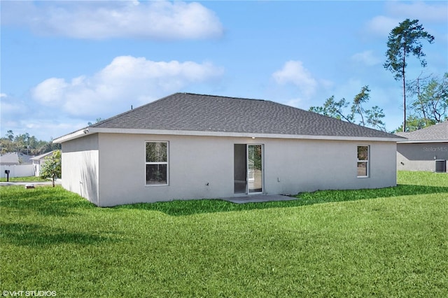 rear view of house with a lawn