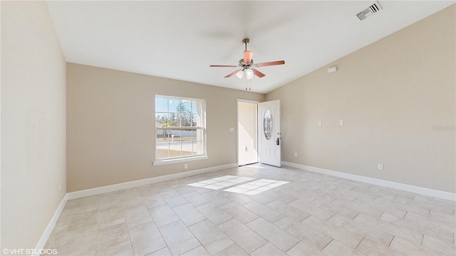 spare room with ceiling fan, light tile patterned flooring, and lofted ceiling