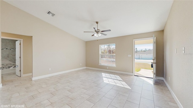 tiled empty room featuring ceiling fan and lofted ceiling