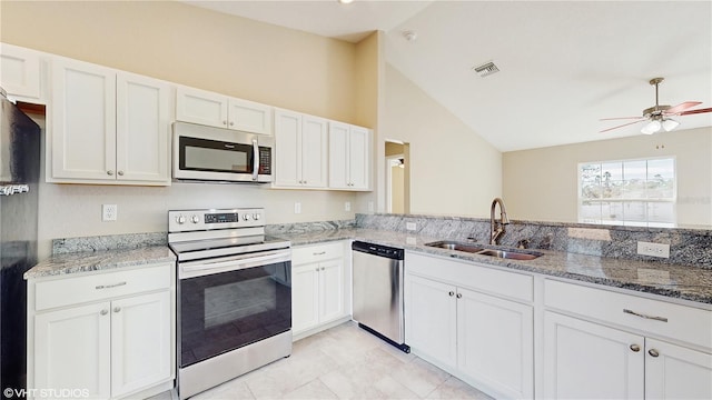 kitchen with white cabinetry, ceiling fan, stainless steel appliances, light stone counters, and sink