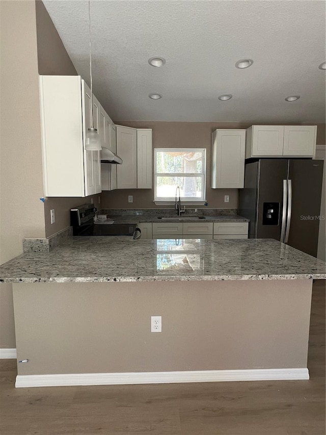 kitchen featuring white cabinetry, sink, range with electric cooktop, and light stone countertops