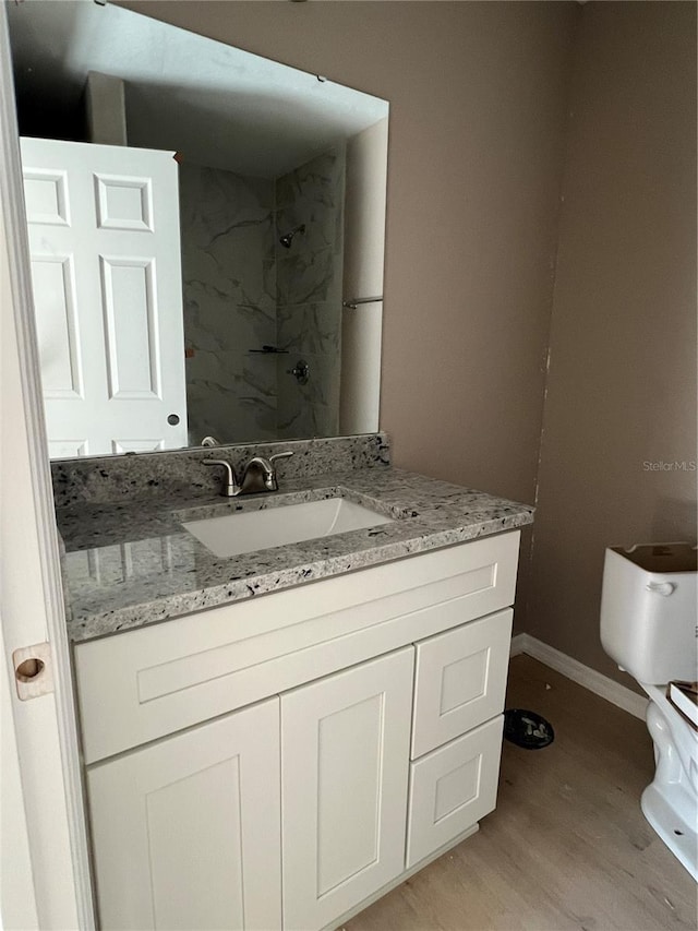 bathroom with hardwood / wood-style flooring and vanity