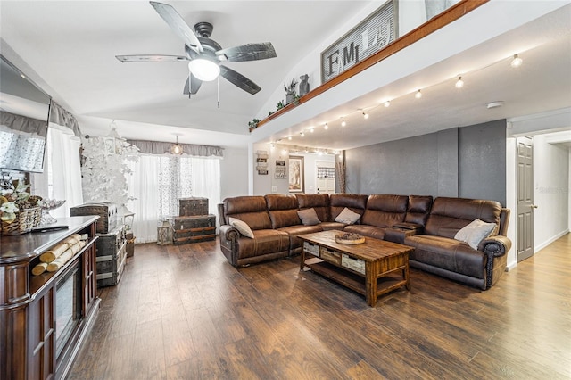 living room with ceiling fan, wood finished floors, and vaulted ceiling