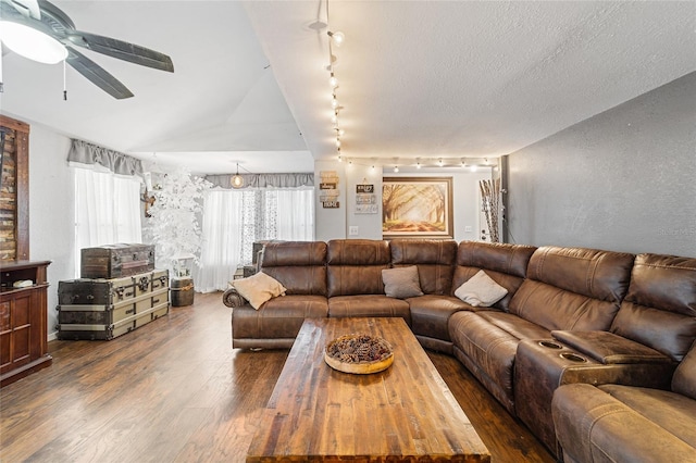 living area featuring vaulted ceiling, a textured ceiling, a ceiling fan, and wood finished floors