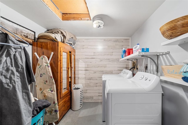 washroom with washer and clothes dryer, laundry area, and wooden walls