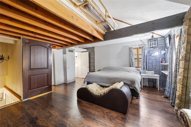 bedroom featuring beam ceiling and hardwood / wood-style floors