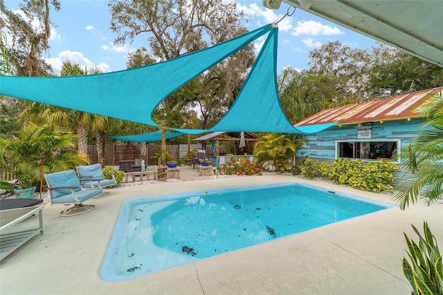 view of pool featuring a patio and fence