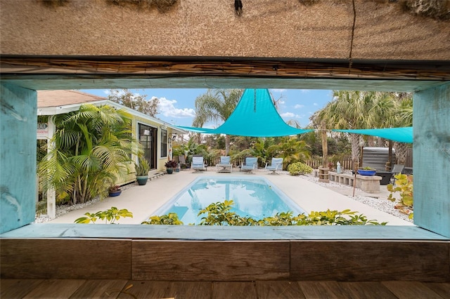 pool with fence and a patio area