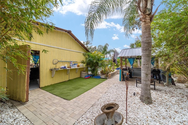 view of patio / terrace with a gazebo and a grill