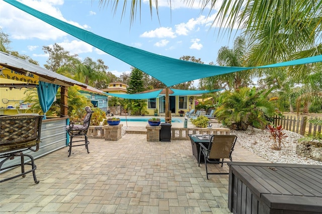 view of patio with fence and an outdoor pool