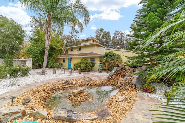 view of front of home featuring fence