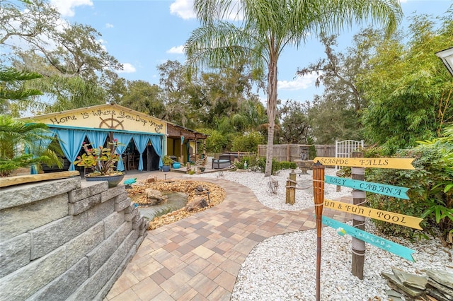 view of community featuring a patio and fence