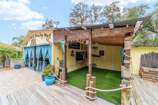 wooden deck featuring a lawn