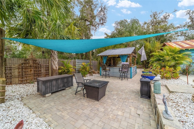 view of patio featuring fence and an outdoor fire pit