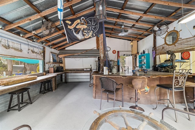 interior space with a workshop area, finished concrete flooring, and lofted ceiling