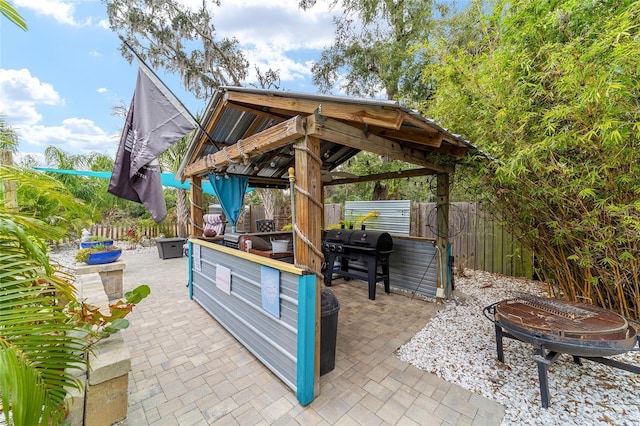 view of patio / terrace with a gazebo, grilling area, and fence