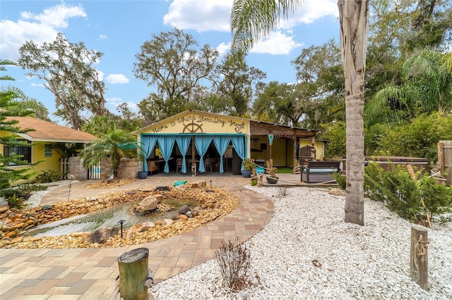 rear view of property with a jacuzzi