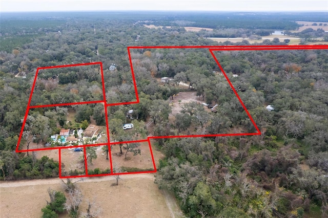 drone / aerial view featuring a forest view