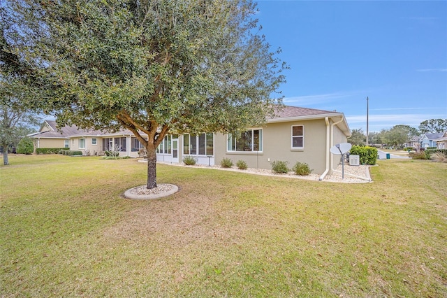 rear view of property featuring a lawn