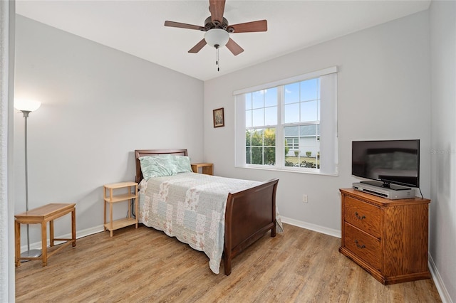 bedroom with ceiling fan and light hardwood / wood-style floors