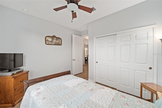 bedroom featuring ceiling fan and a closet