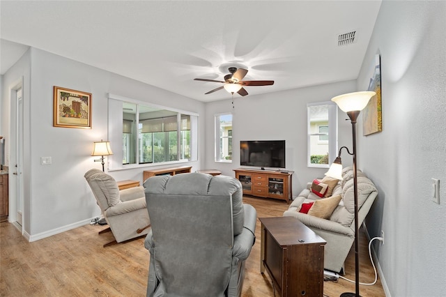 living room featuring ceiling fan and light hardwood / wood-style flooring