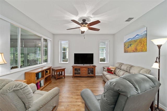 living room featuring light hardwood / wood-style floors and ceiling fan