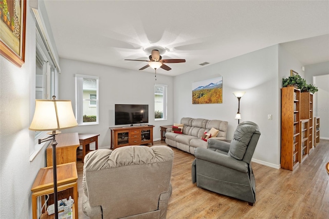 living room featuring ceiling fan and light wood-type flooring