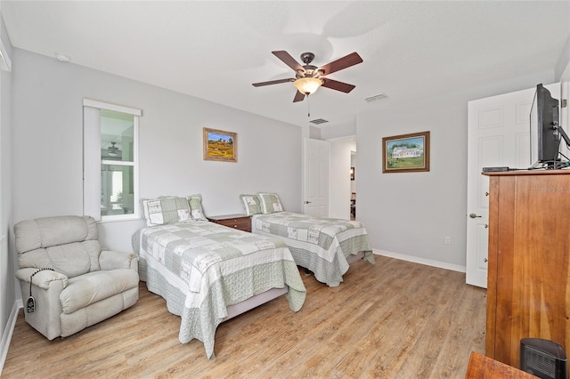 bedroom with ceiling fan and light wood-type flooring