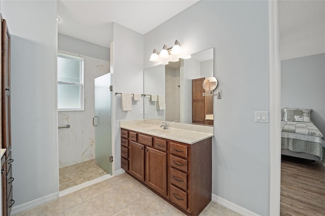 bathroom featuring vanity and a shower with door