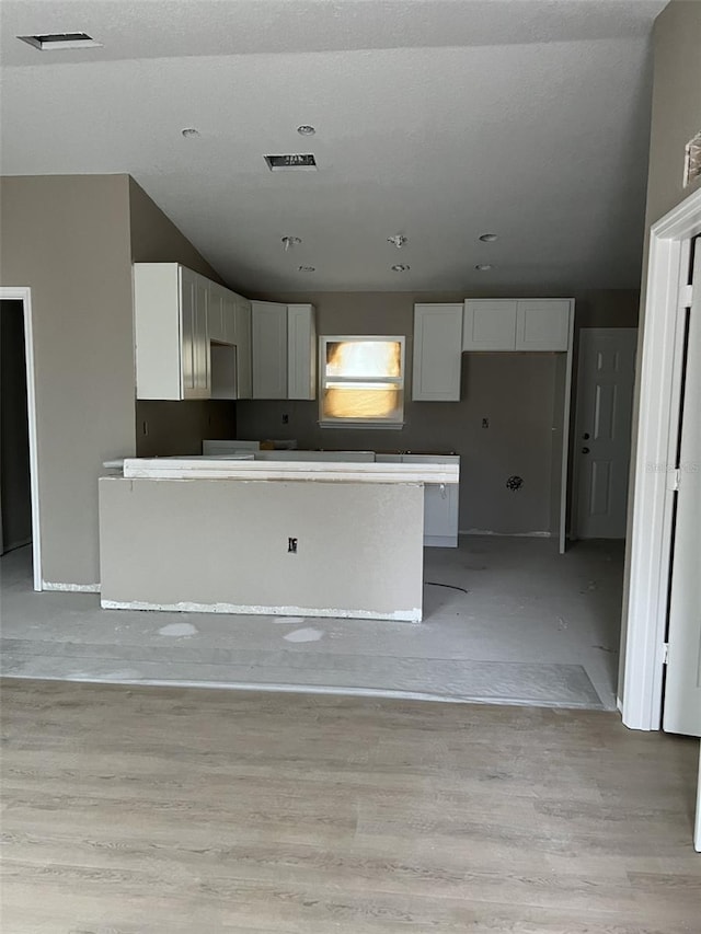 kitchen featuring a center island and white cabinetry