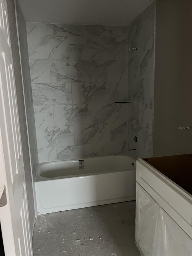 bathroom with vanity and tiled shower / bath