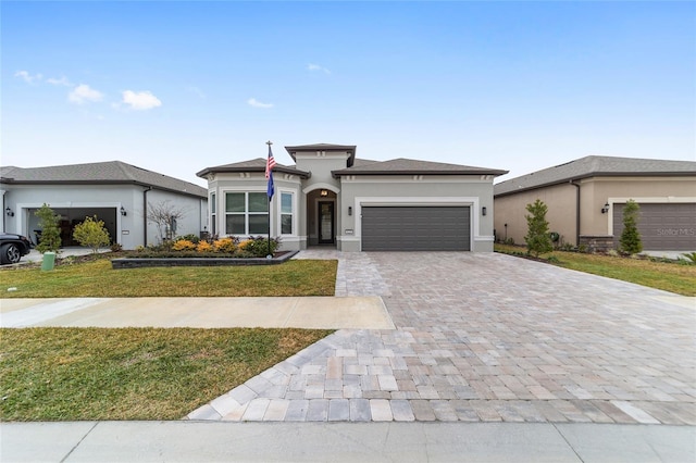 prairie-style house with a front yard and a garage