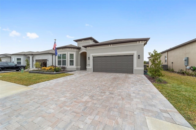 prairie-style house with a garage and a front yard