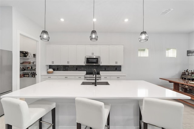 kitchen featuring white cabinetry, pendant lighting, and sink