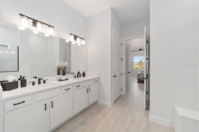 bathroom featuring ceiling fan, hardwood / wood-style floors, and vanity