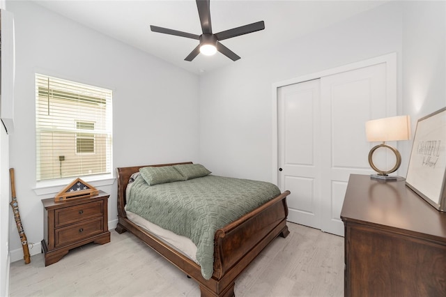 bedroom with ceiling fan, a closet, and light hardwood / wood-style floors