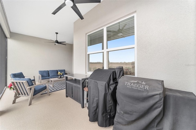 view of patio with ceiling fan and an outdoor living space